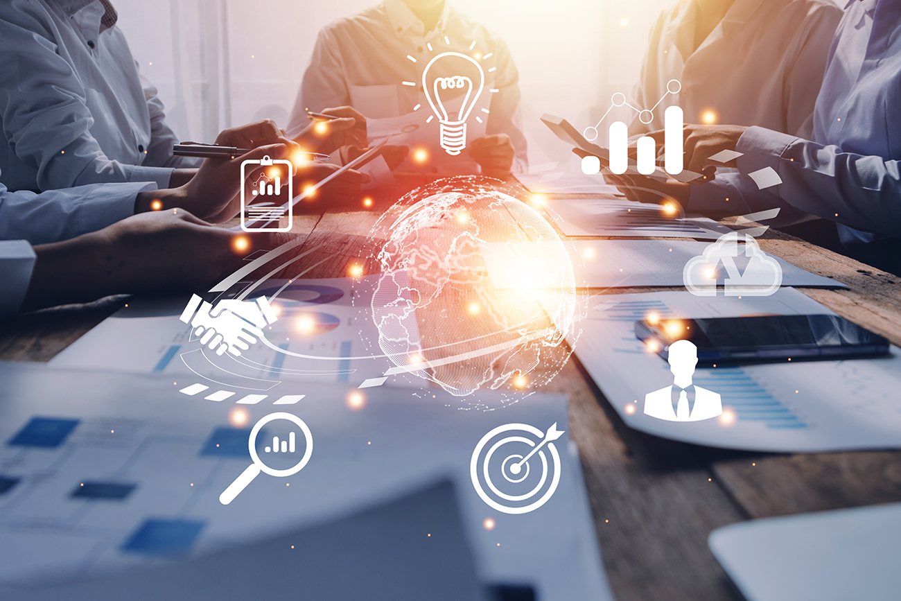 People at a table using electronic devices with interconnected resources | ©ARMMY PICCA / iStock / Getty Images Plus